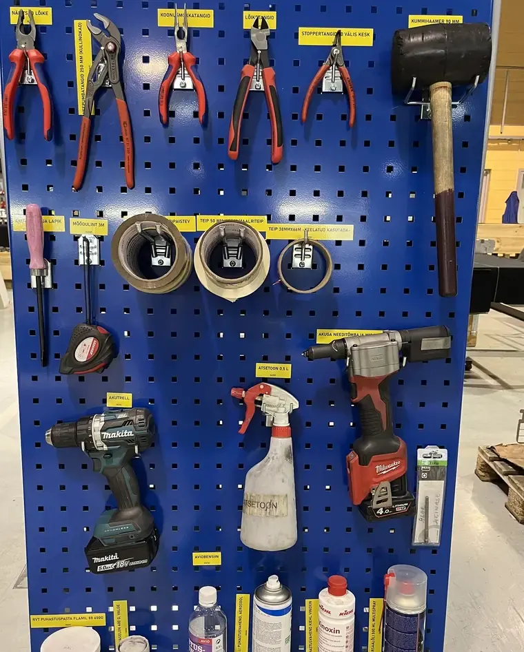 Cleaning supplies kept in their own holders at the workstation