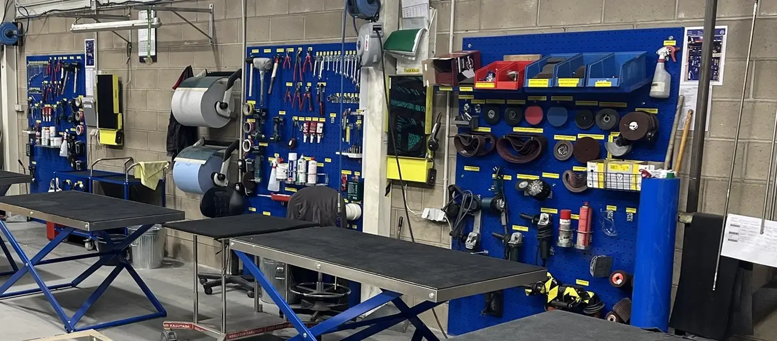 Row of workstations, each with its own shadow board and labelled tools